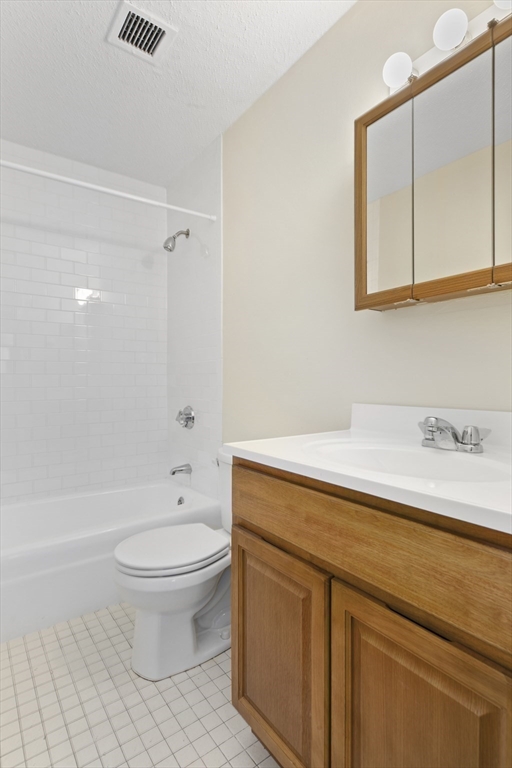 68 Main Street, Unit 17C Stoneham, MA 02180 - Photo 10 of 13 a bathroom with a sink a toilet and a bathtub
