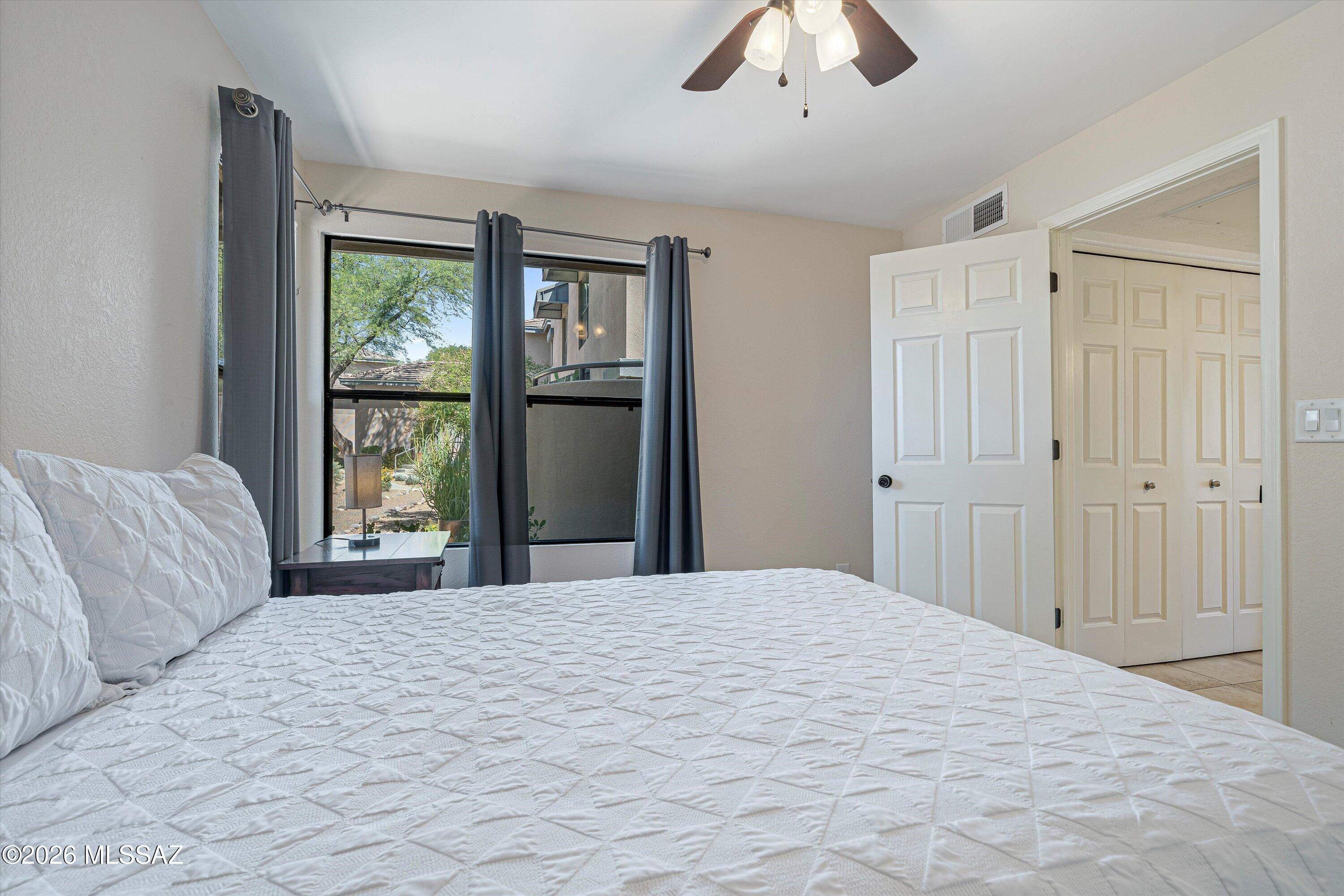 5800 North Kolb Road, Unit 5125 Tucson, AZ 85750 - Photo 21 of 34 a bedroom with a large bed and a window