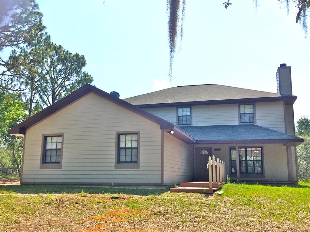 5665 Southwest 137th Court Ocala, FL 34481 - Photo 1 of 1 a front view of a house with a yard