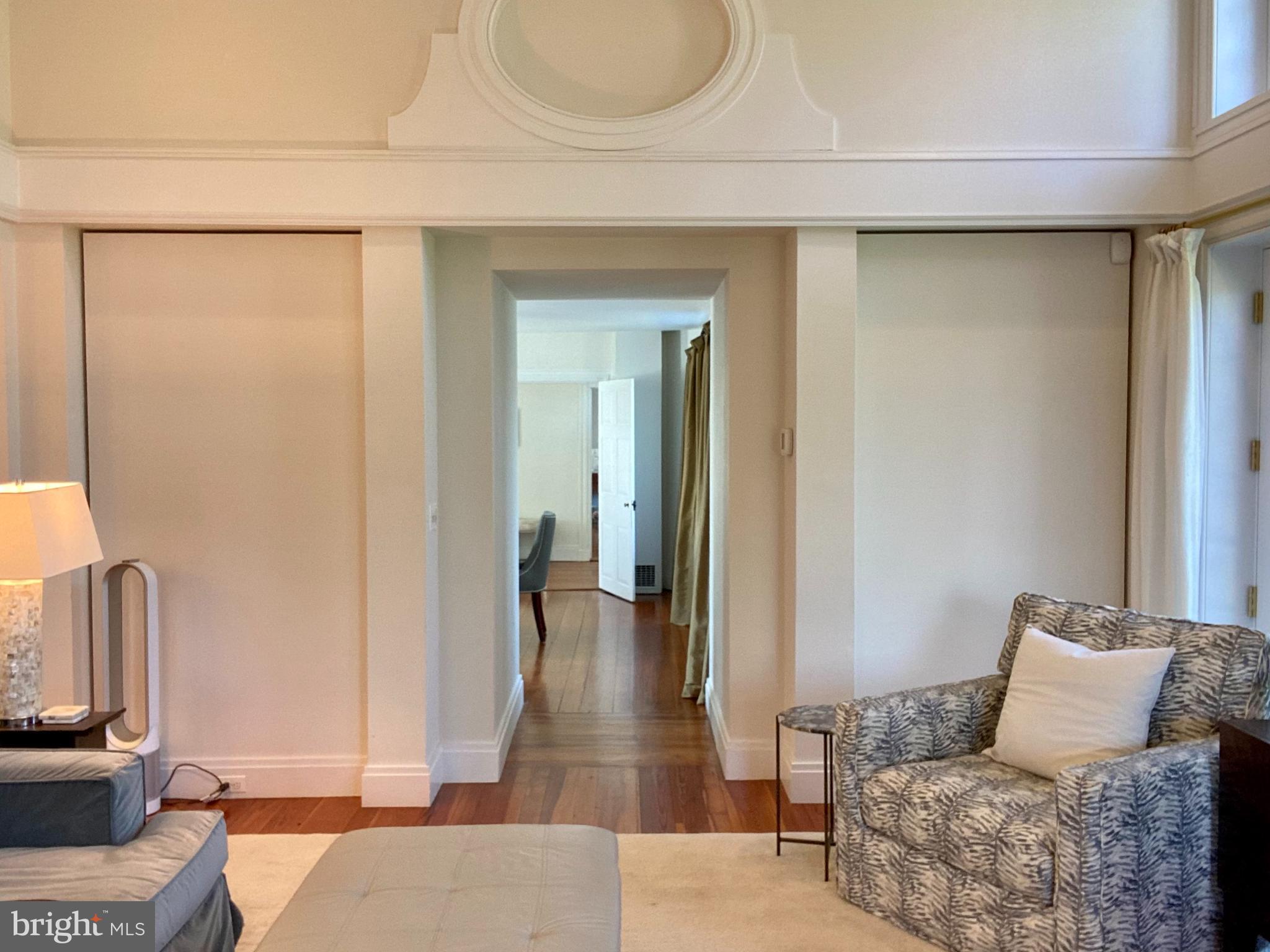 121 Upnor Road Baltimore, MD 21212 - Photo 24 of 79 a hallway with a couch and a potted plant with wooden floor