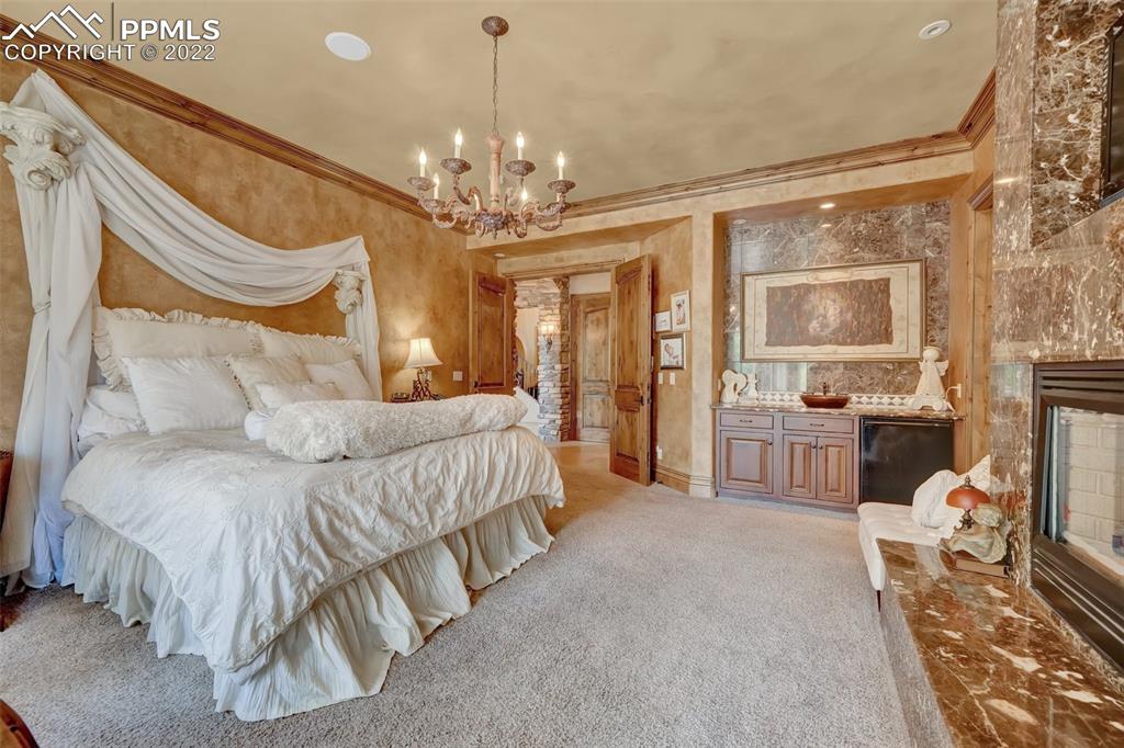 4 3rd Street Colorado Springs, CO 80906 - Photo 14 of 50 a spacious bedroom with a bed and a chandelier
