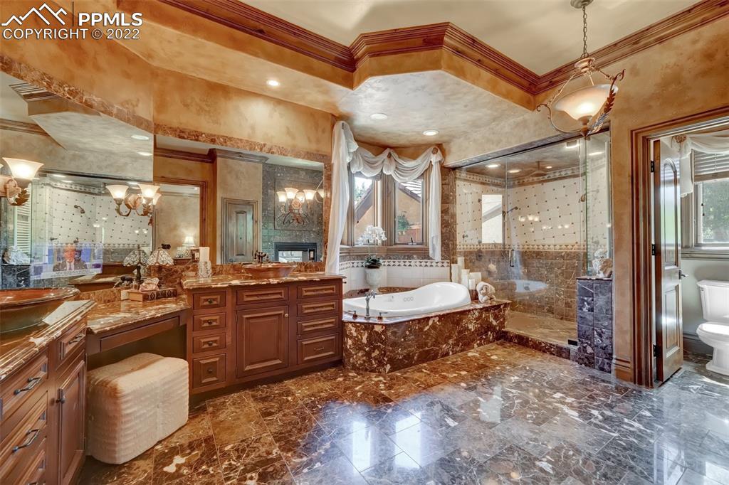 4 3rd Street Colorado Springs, CO 80906 - Photo 16 of 50 a large bathroom with a large mirror vanity and sink