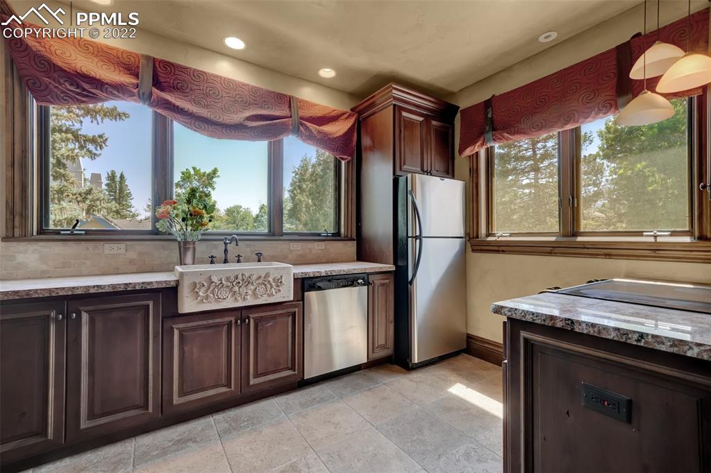 4 3rd Street Colorado Springs, CO 80906 - Photo 29 of 50 a kitchen with stainless steel appliances granite countertop a sink and a refrigerator
