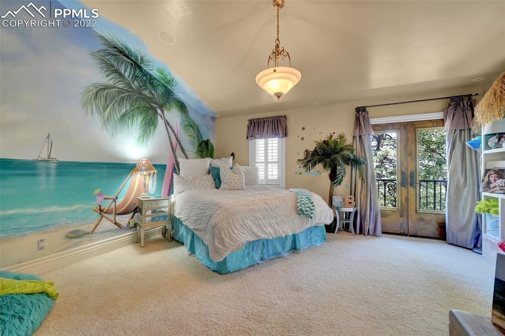 4 3rd Street Colorado Springs, CO 80906 - Photo 32 of 50 a spacious bedroom with a bed and a chandelier