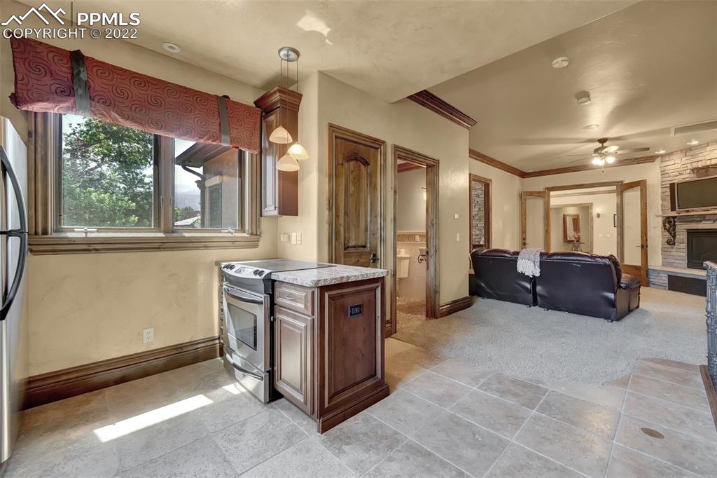 4 3rd Street Colorado Springs, CO 80906 - Photo 39 of 50 a large kitchen with stainless steel appliances granite countertop a stove and a sink