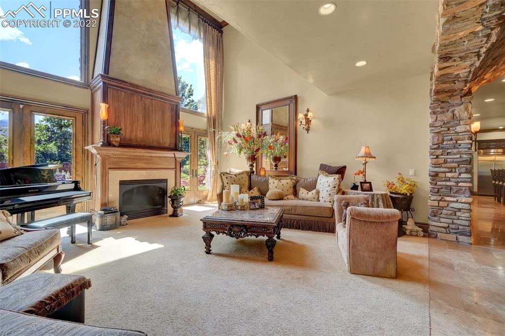 4 3rd Street Colorado Springs, CO 80906 - Photo 6 of 50 a living room with furniture a fireplace and a floor to ceiling window