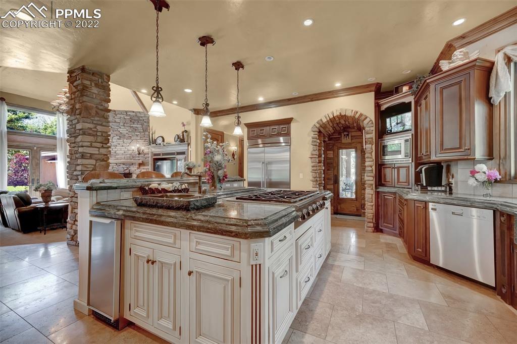 4 3rd Street Colorado Springs, CO 80906 - Photo 8 of 50 a kitchen with stainless steel appliances granite countertop a stove a sink and a refrigerator