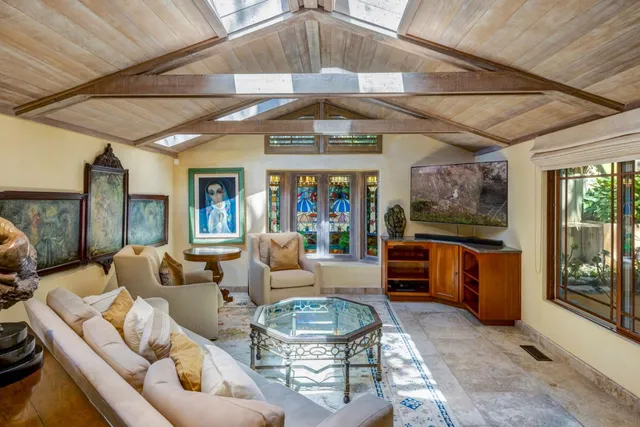 a living room with furniture and a chandelier