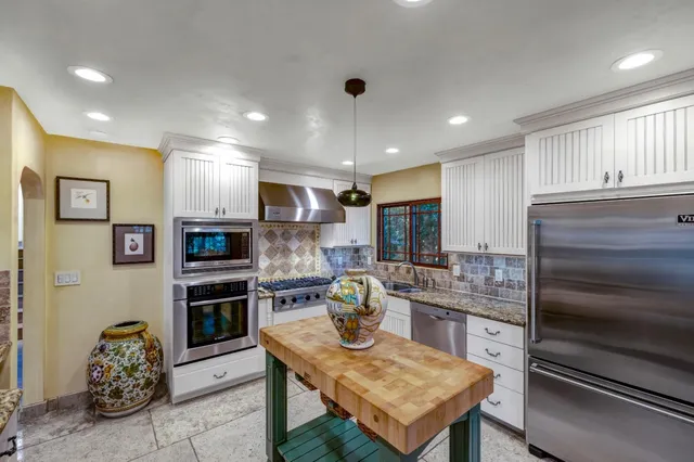 a kitchen with cabinets and appliances