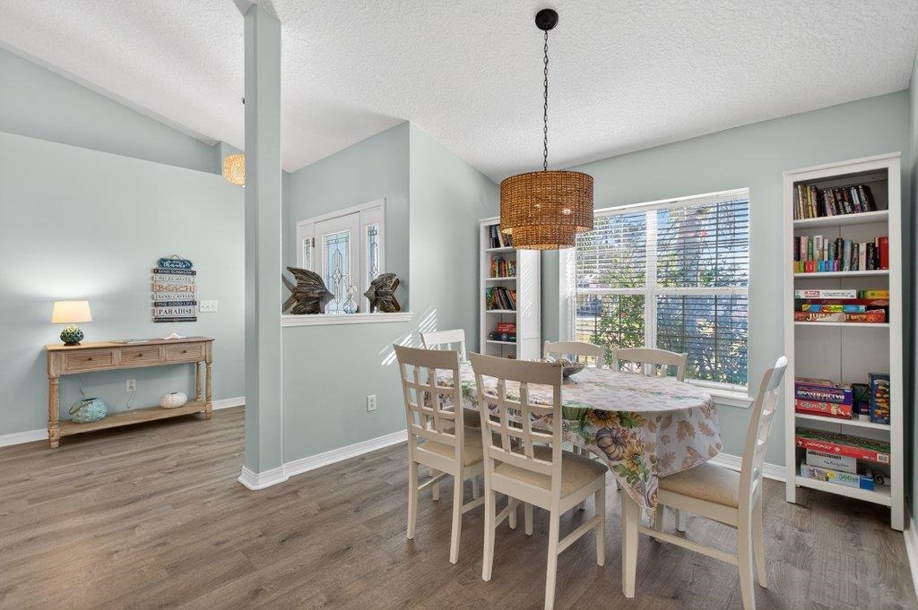 254 Basque Road St. Augustine, FL 32080 - Photo 20 of 67 a dining room with furniture a chandelier and wooden floor