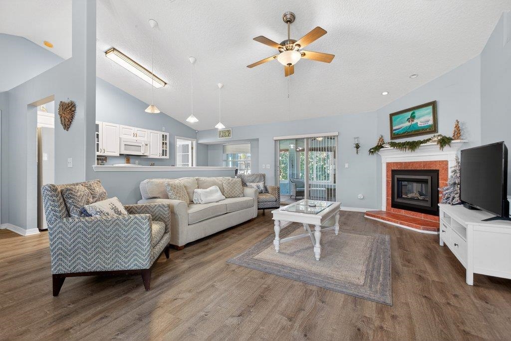 254 Basque Road St. Augustine, FL 32080 - Photo 23 of 67 a living room with furniture fireplace and a flat screen tv