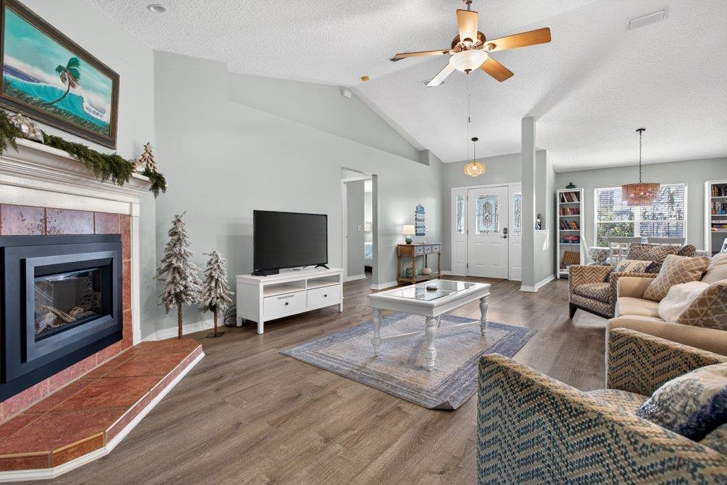 254 Basque Road St. Augustine, FL 32080 - Photo 24 of 67 a living room with furniture a flat screen tv and a fireplace