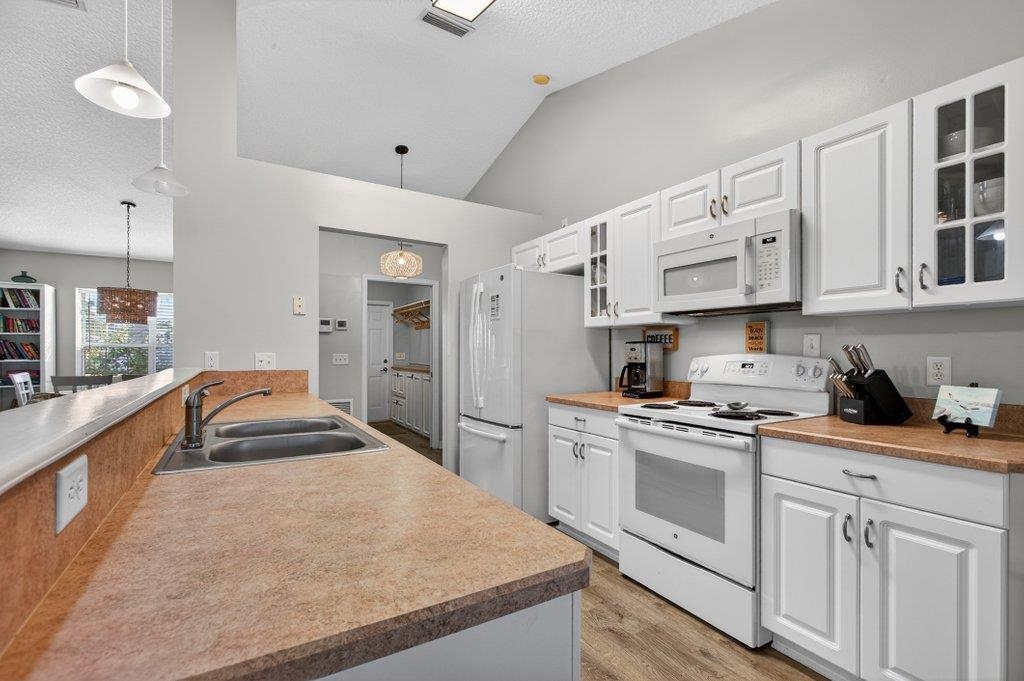 254 Basque Road St. Augustine, FL 32080 - Photo 25 of 67 a kitchen with stainless steel appliances granite countertop a sink and cabinets