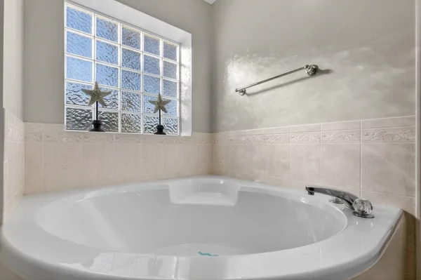 a bathroom with a tub sink and a mirror