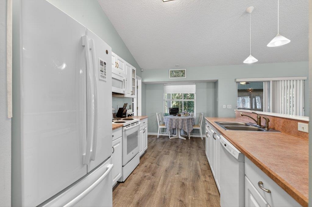 254 Basque Road St. Augustine, FL 32080 - Photo 27 of 67 a large kitchen with stainless steel appliances granite countertop a lot of counter space and wooden floors