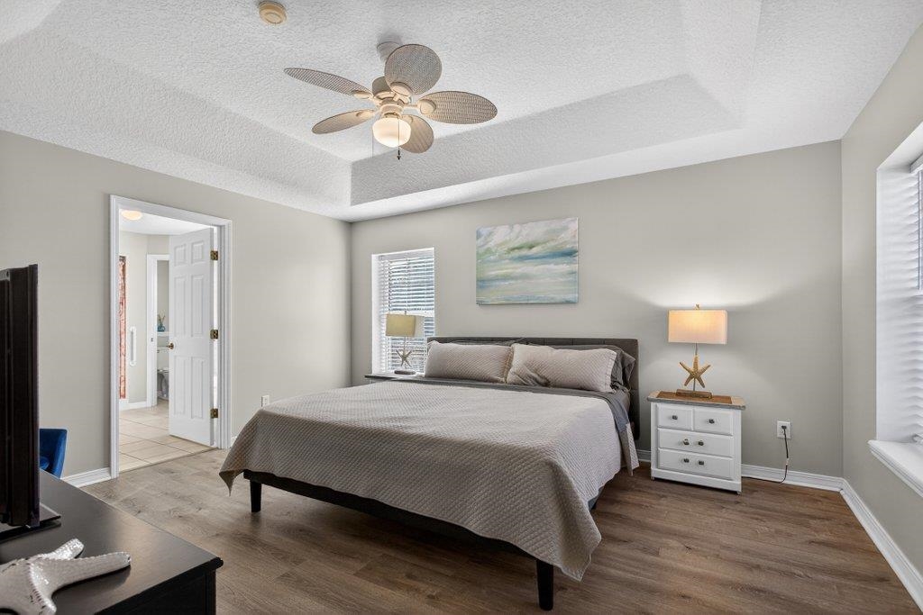 254 Basque Road St. Augustine, FL 32080 - Photo 31 of 67 a bedroom with a bed and a chandelier