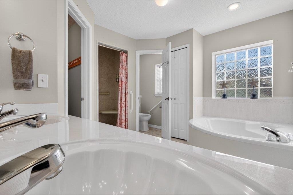 254 Basque Road St. Augustine, FL 32080 - Photo 35 of 67 a bathroom with a tub sink and a mirror