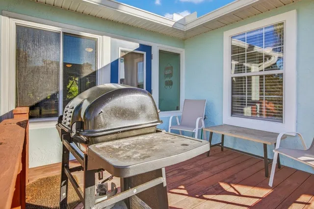 a balcony with furniture and a potted plant