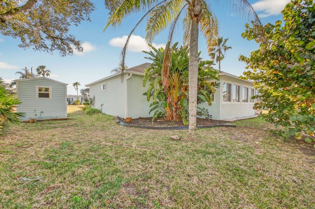 254 Basque Road St. Augustine, FL 32080 - Photo 54 of 67 View of property exterior featuring a lawn, stucco siding, and a sunroom