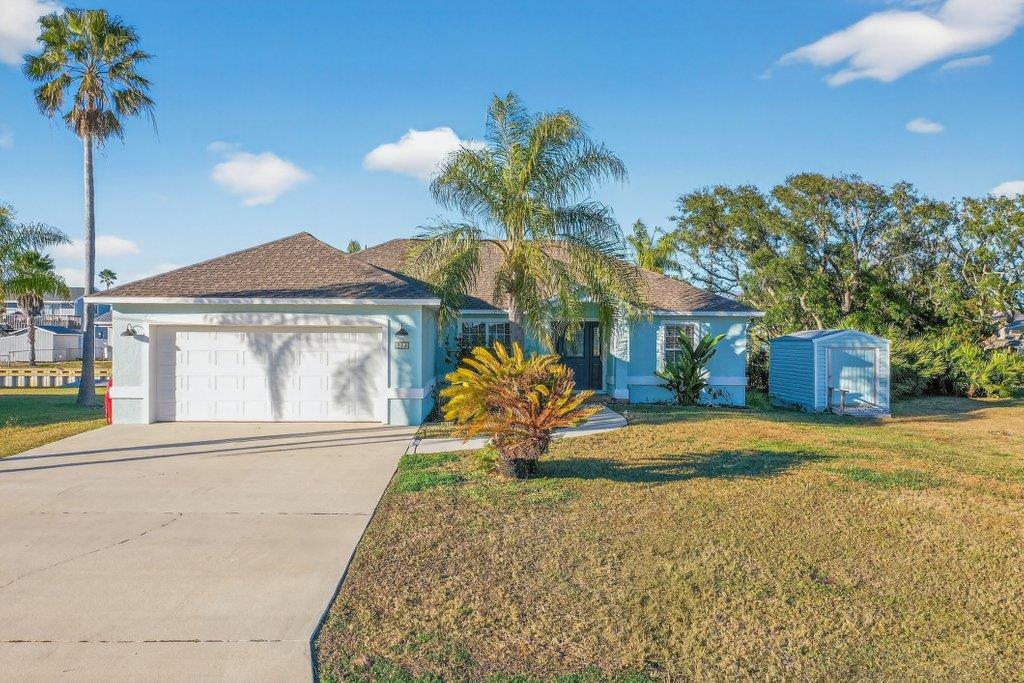 254 Basque Road St. Augustine, FL 32080 - Photo 58 of 67 Ranch-style home with a front lawn, a garage, driveway, and stucco siding