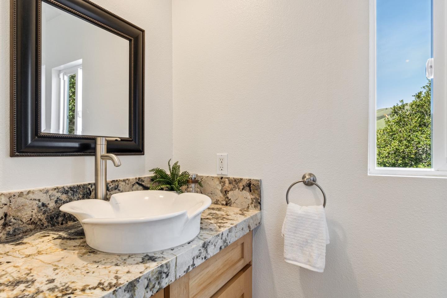 320 El Caminito Road Carmel Valley, CA 93924 - Photo 41 of 62 a bathroom with a granite countertop sink and a mirror