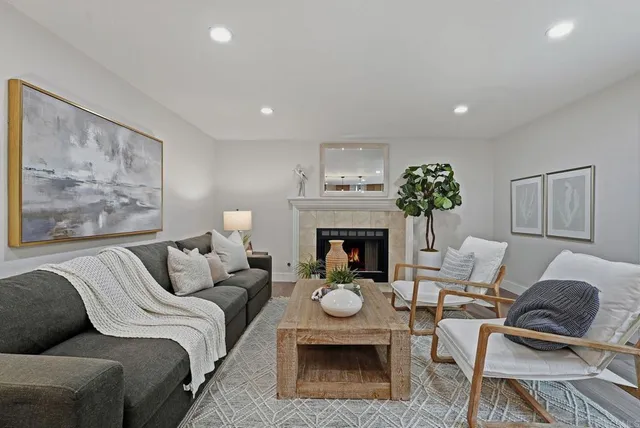 a living room with furniture and a fireplace