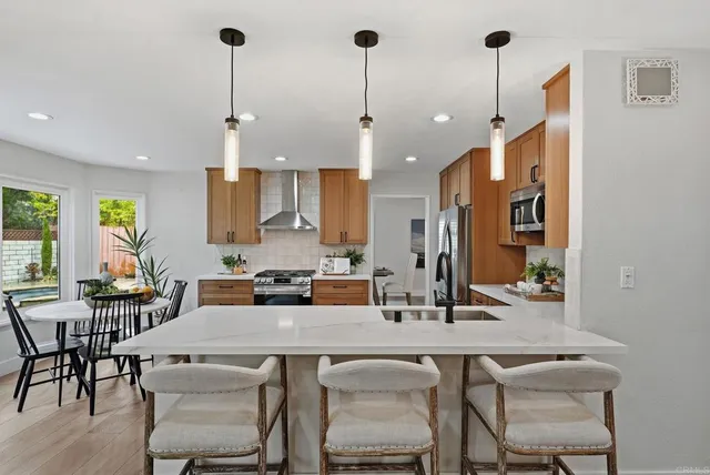 a kitchen with a table chairs stove and cabinets