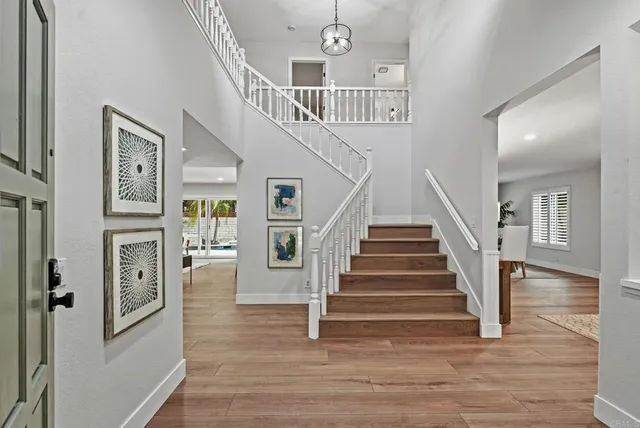 a view of entryway and hall with wooden floor