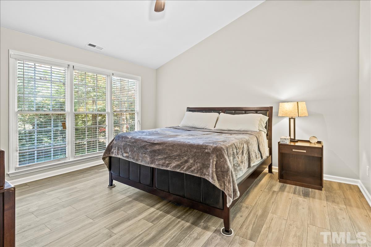 4737 Sinclair Drive Raleigh, NC 27616 - Photo 17 of 29 a bedroom with a bed and wooden floor