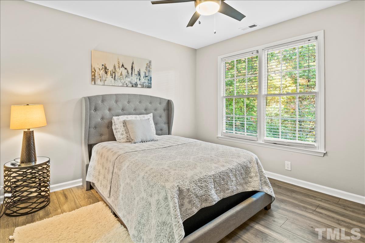 4737 Sinclair Drive Raleigh, NC 27616 - Photo 22 of 29 a bedroom with a bed and a lamp