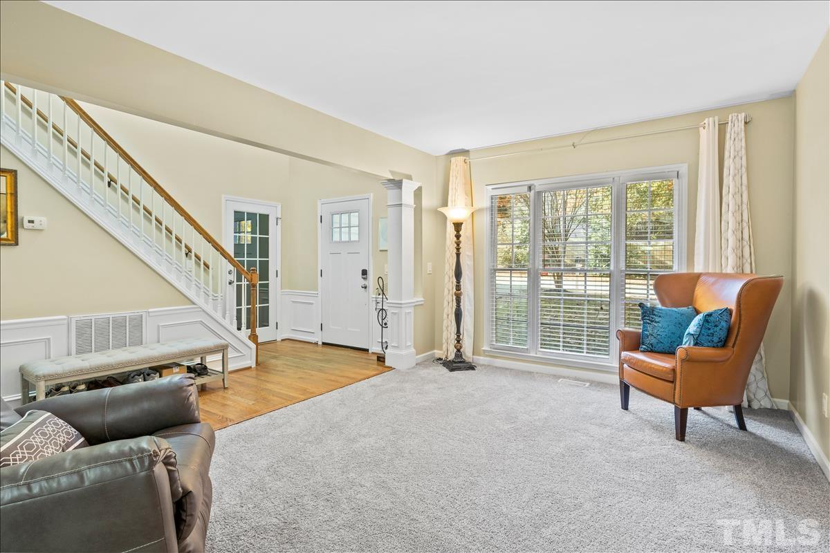 4737 Sinclair Drive Raleigh, NC 27616 - Photo 6 of 29 a living room with furniture and a floor to ceiling window
