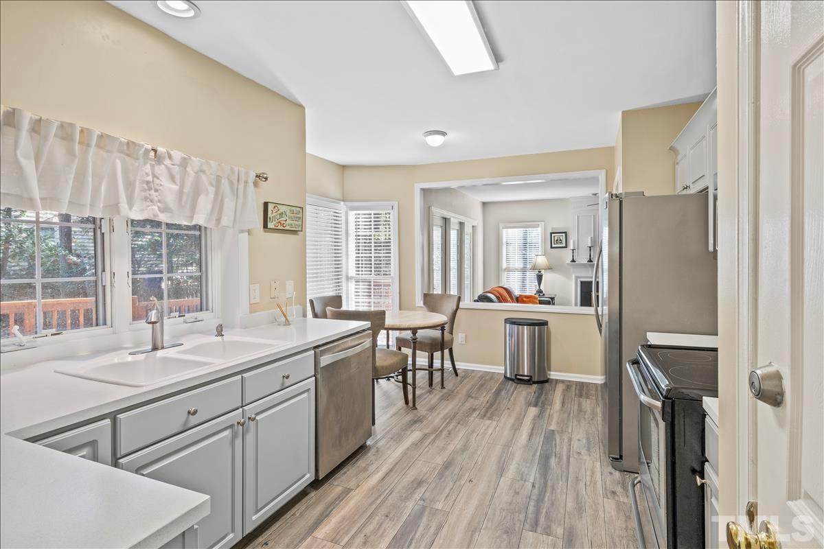 4737 Sinclair Drive Raleigh, NC 27616 - Photo 10 of 29 a kitchen with a sink stove and refrigerator