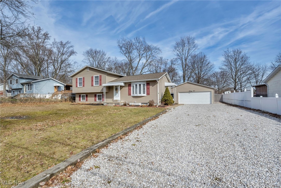 4079 Pardee Road Stow, OH 44224 - Photo 1 of 1 View of front of home featuring a garage, an outdoor structure, fence, and a front yard