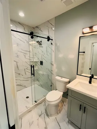 a bathroom with a shower sink and mirror