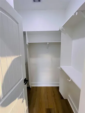 a view of a room with wooden floor and furniture