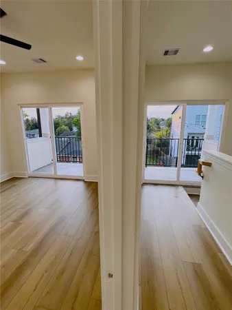 a view of hallway with wooden floor