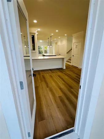 a view of kitchen with kitchen island wooden floor and center island