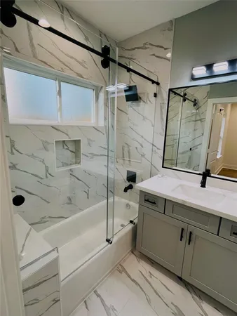 a bathroom with a tub and a shower