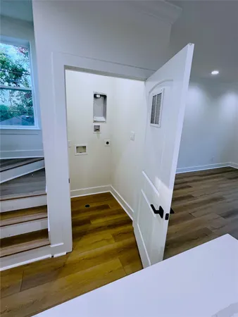 an empty room with windows and ceiling fan