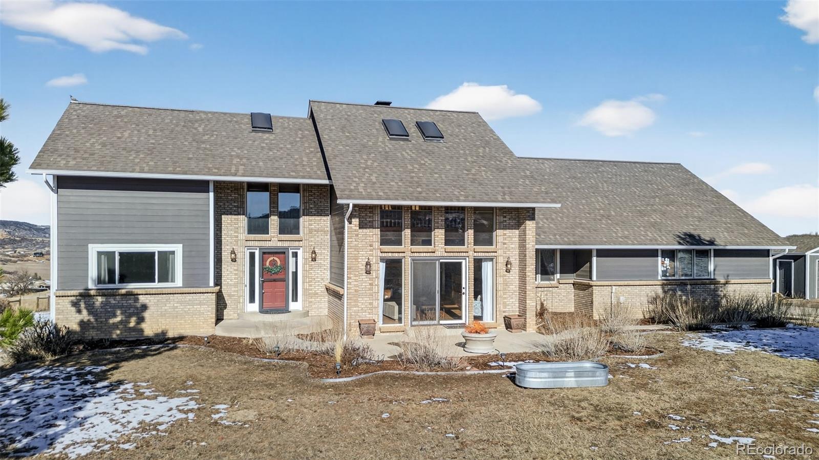 4205 West Parkridge Road Sedalia, CO 80135 - Photo 1 of 50 a front view of a house with sitting area