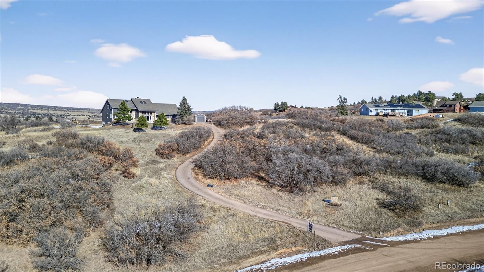 4205 West Parkridge Road Sedalia, CO 80135 - Photo 11 of 50 a view of a dry yard with wooden fence