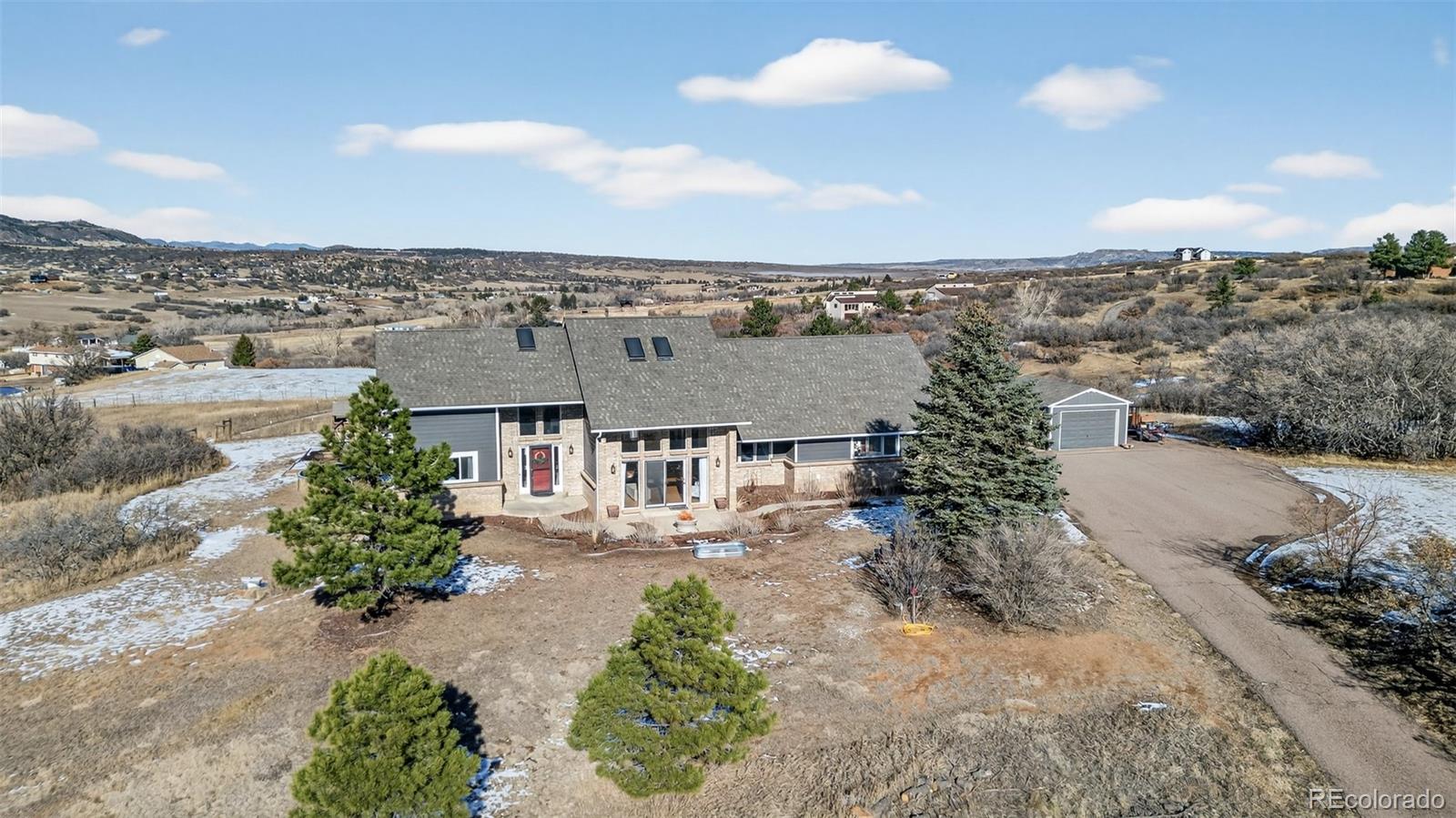 4205 West Parkridge Road Sedalia, CO 80135 - Photo 2 of 50 an aerial view of a house with a yard and lake view in back