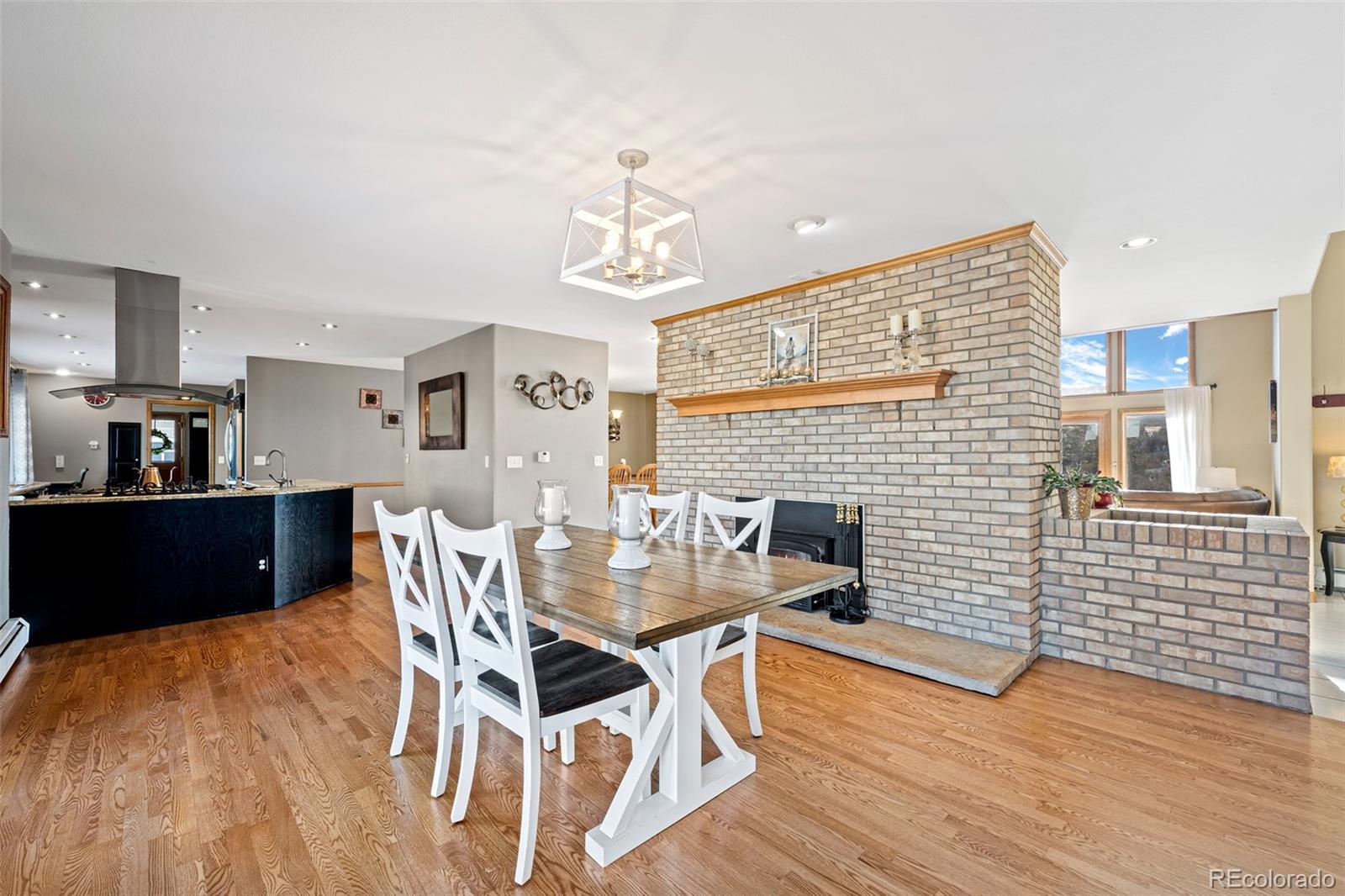 4205 West Parkridge Road Sedalia, CO 80135 - Photo 22 of 50 a view of a dining room with furniture and wooden floor