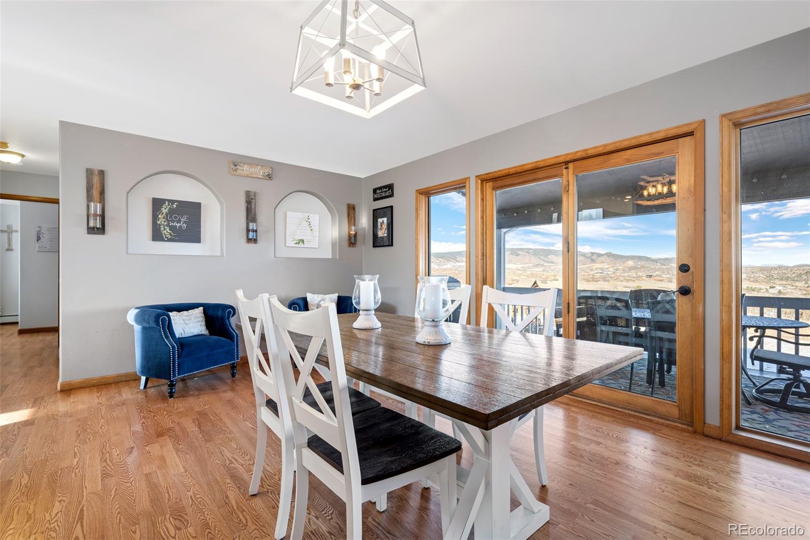4205 West Parkridge Road Sedalia, CO 80135 - Photo 24 of 50 a view of a dining room with furniture window and wooden floor