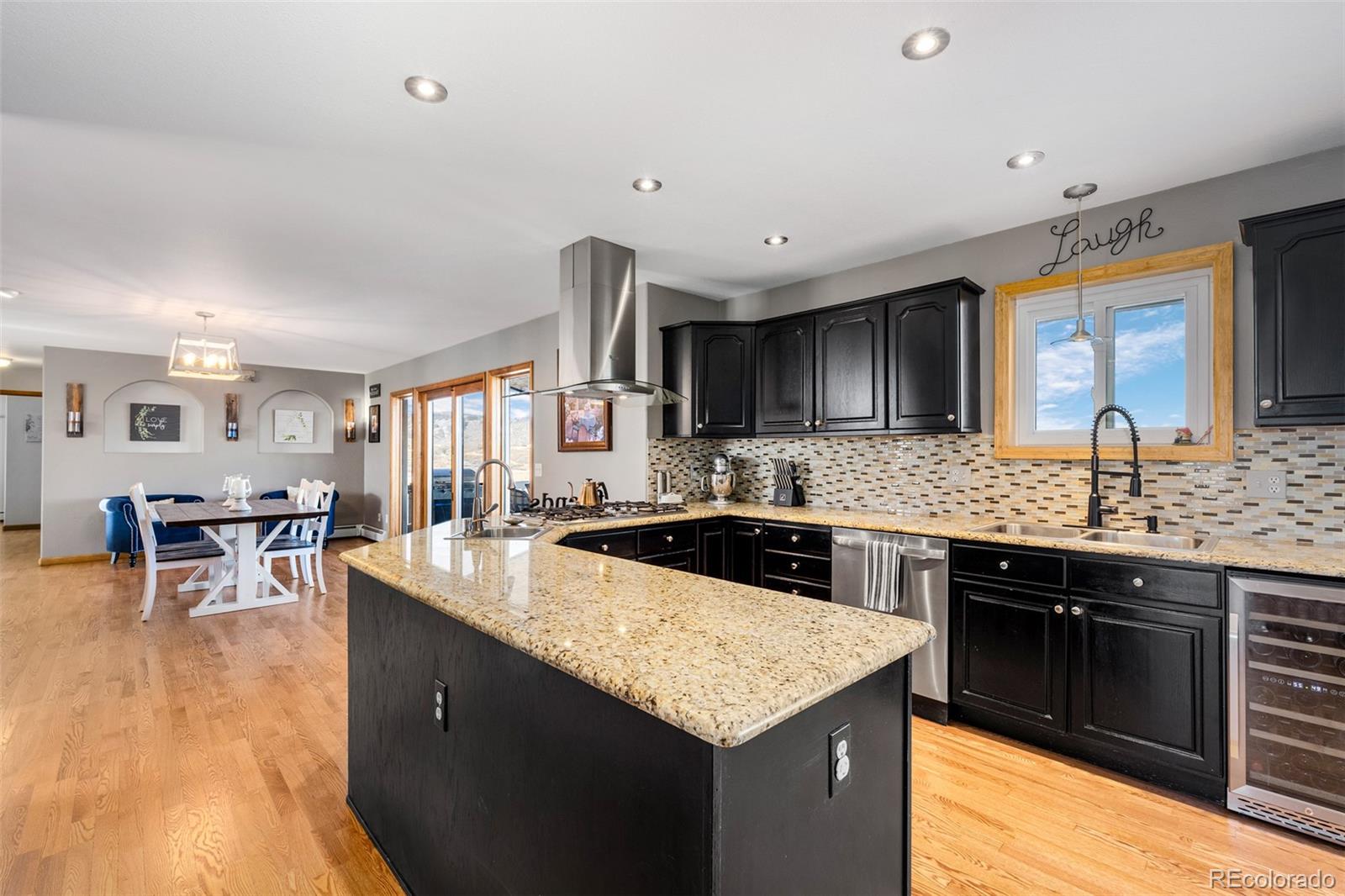 4205 West Parkridge Road Sedalia, CO 80135 - Photo 26 of 50 a kitchen with granite countertop a sink and cabinets