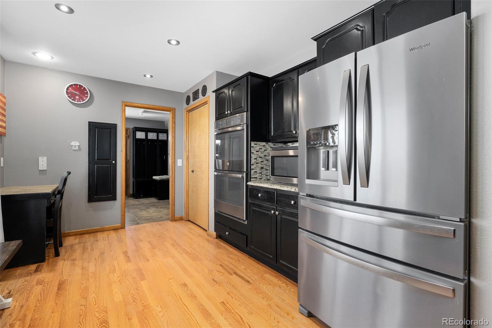 4205 West Parkridge Road Sedalia, CO 80135 - Photo 28 of 50 a kitchen with stainless steel appliances granite countertop a refrigerator and a sink