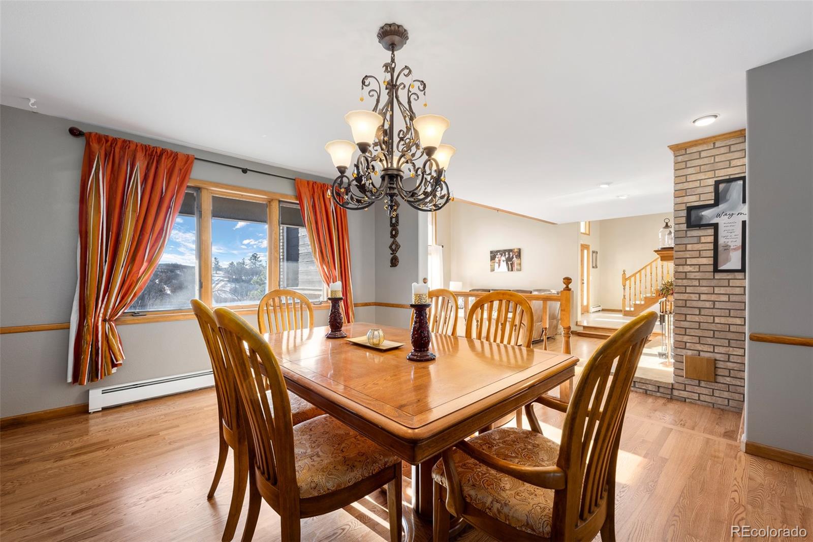 4205 West Parkridge Road Sedalia, CO 80135 - Photo 30 of 50 a view of a dining room with furniture window and wooden floor