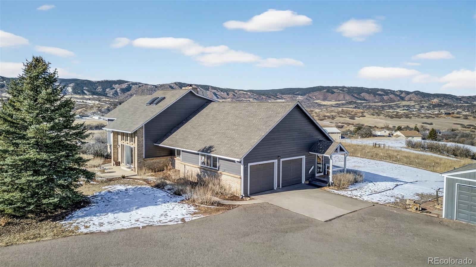 4205 West Parkridge Road Sedalia, CO 80135 - Photo 3 of 50 a front view of a house with a yard