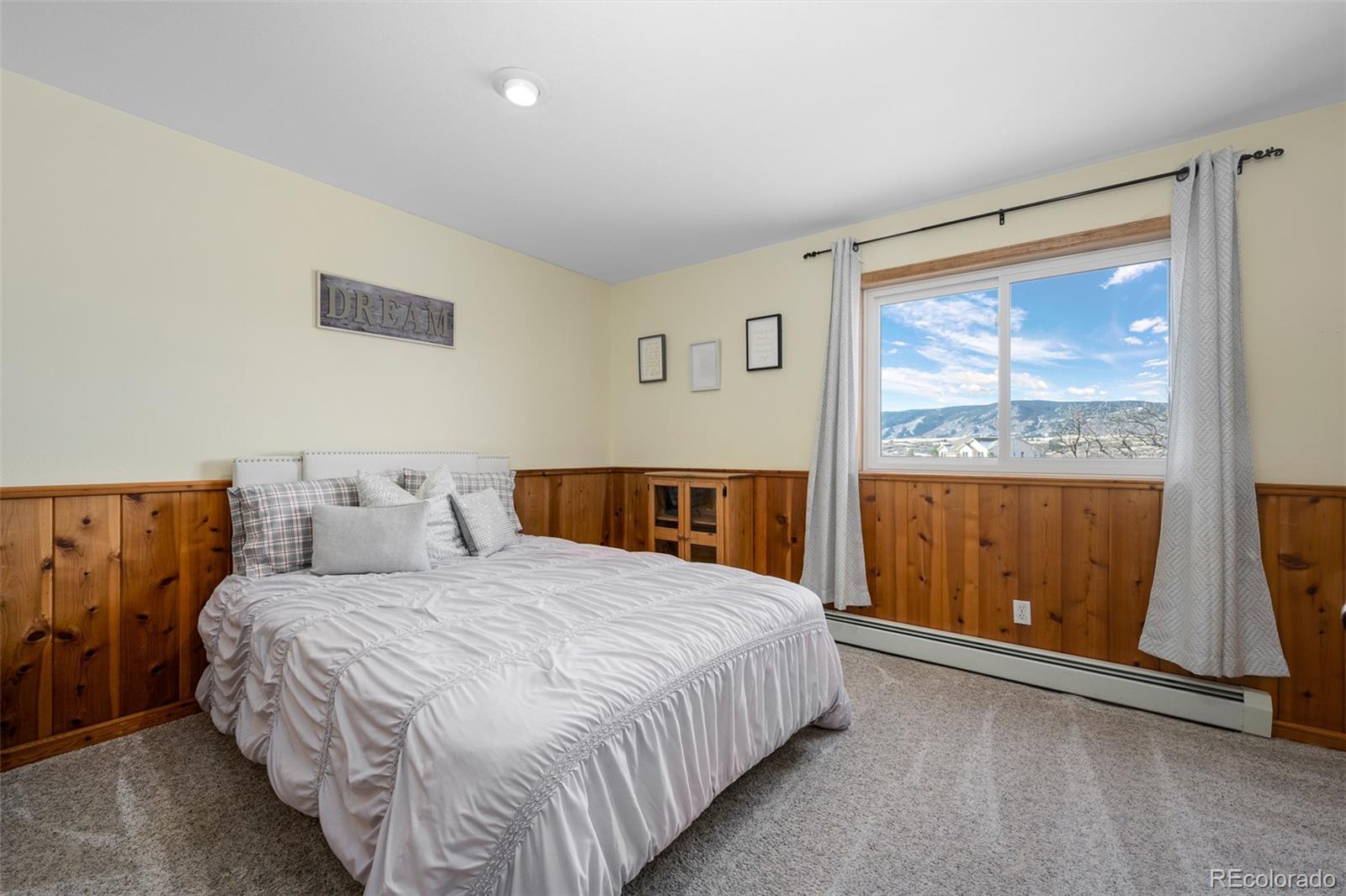 4205 West Parkridge Road Sedalia, CO 80135 - Photo 47 of 50 a bedroom with a large bed and a large window