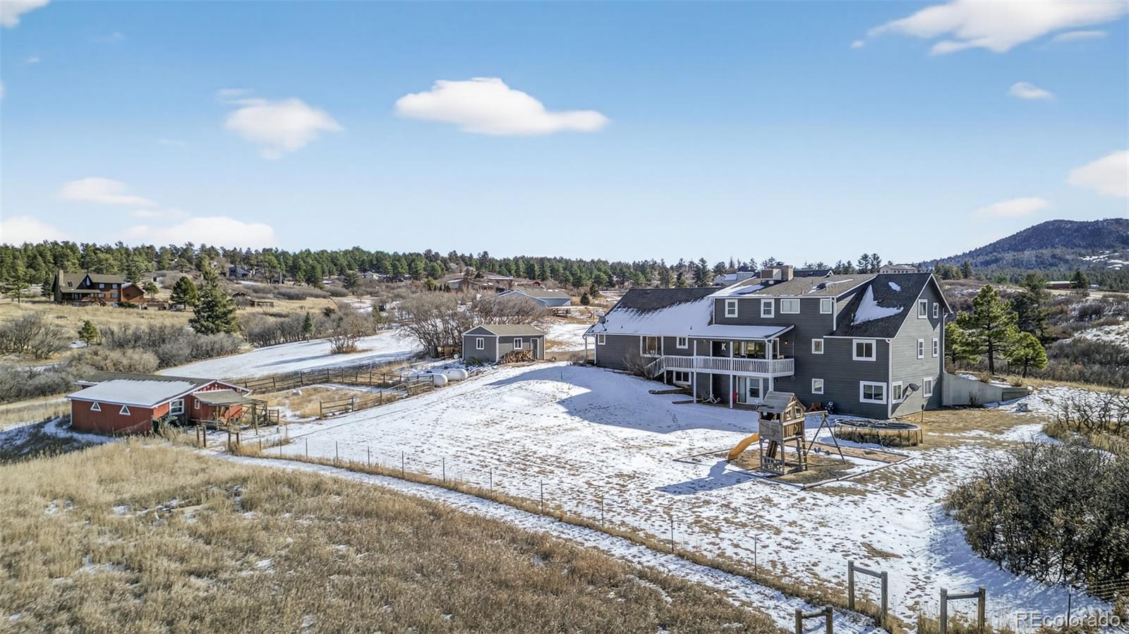 4205 West Parkridge Road Sedalia, CO 80135 - Photo 5 of 50 a view of a town with big house